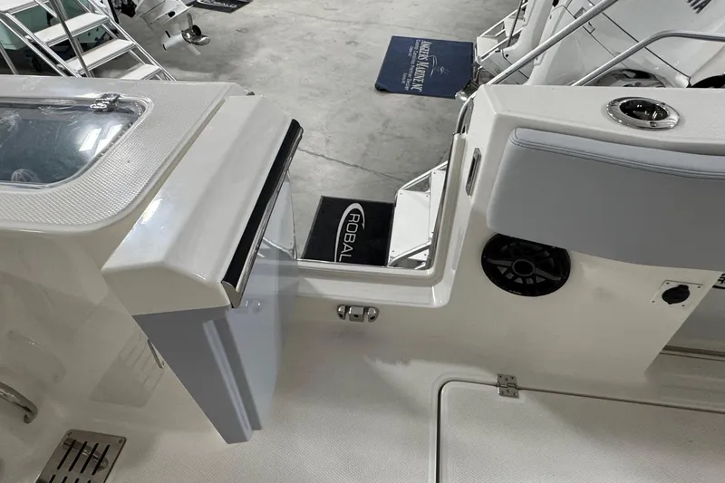 Slide: The Image of 2026 Robalo R300 Center Console boat interior with open storage compartment and seating. - 15