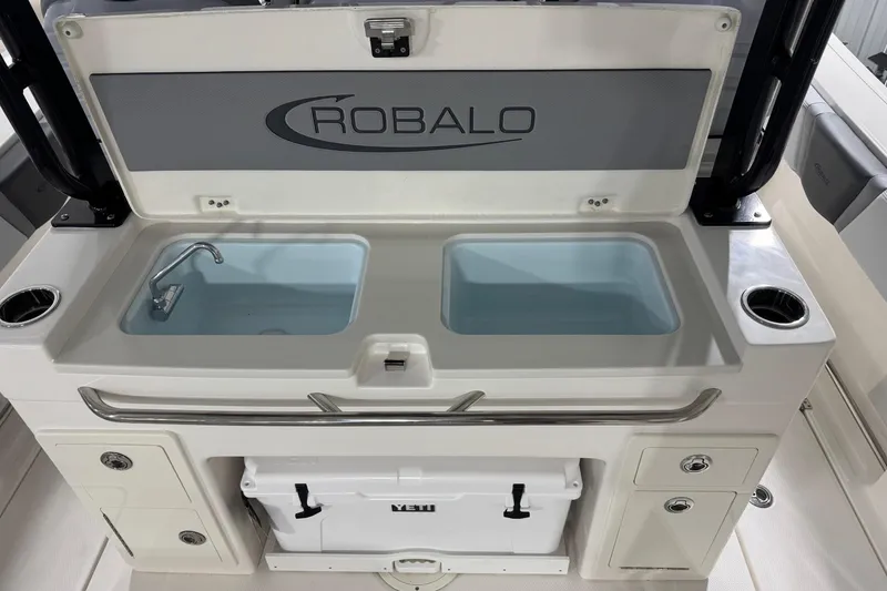 Slide: The Image of 2026 Robalo R300 Center Console boat with dual sinks and storage compartments. - 16