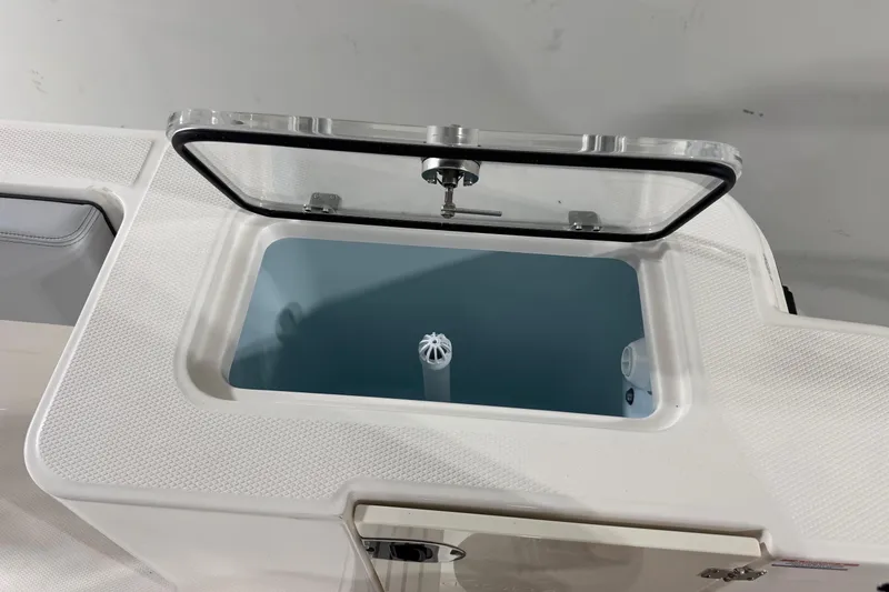 Slide: The Image of Open storage compartment on 2026 Robalo R300 Center Console boat. - 17