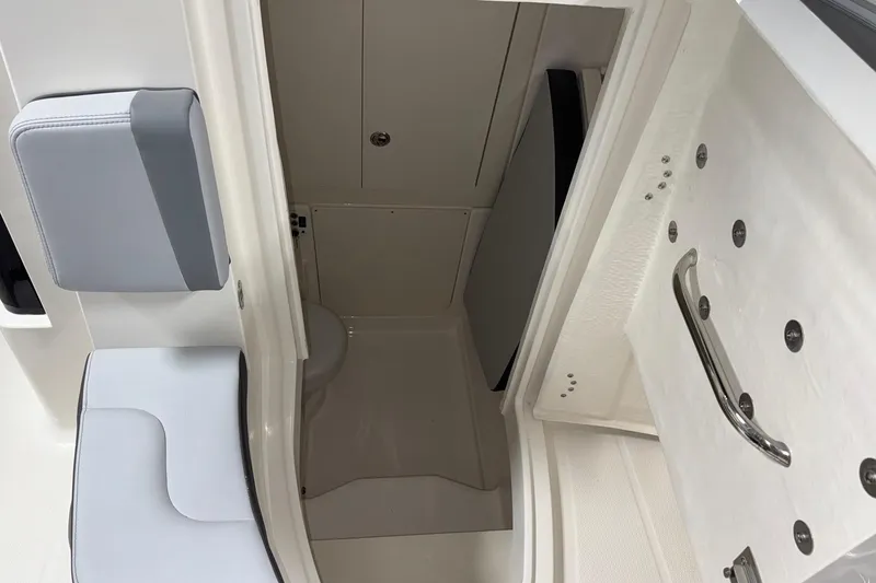 Slide: The Image of Interior view of 2026 Robalo R300 Center Console boat's compact cabin space. - 19