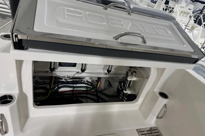 Slide: The Image of 2026 Robalo R300 Center Console boat interior wiring and storage compartment. - 25