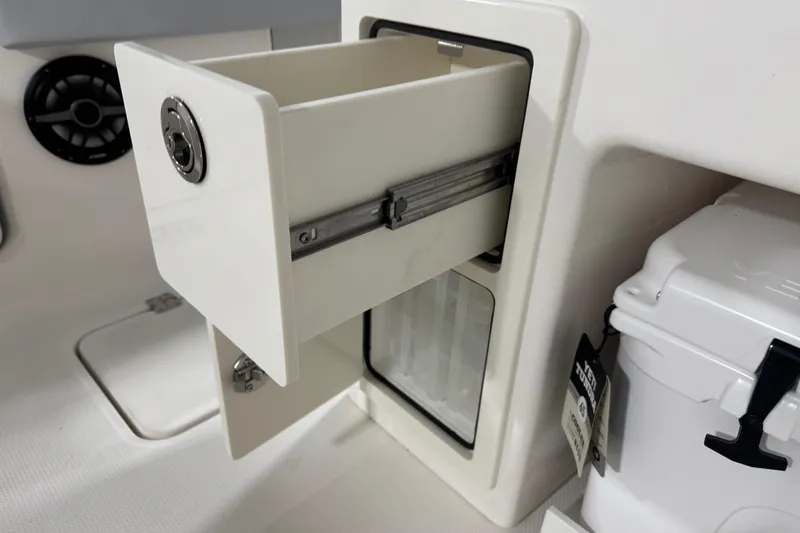 Slide: The Image of 2026 Robalo R300 Center Console storage compartment with open drawer and cooler. - 27