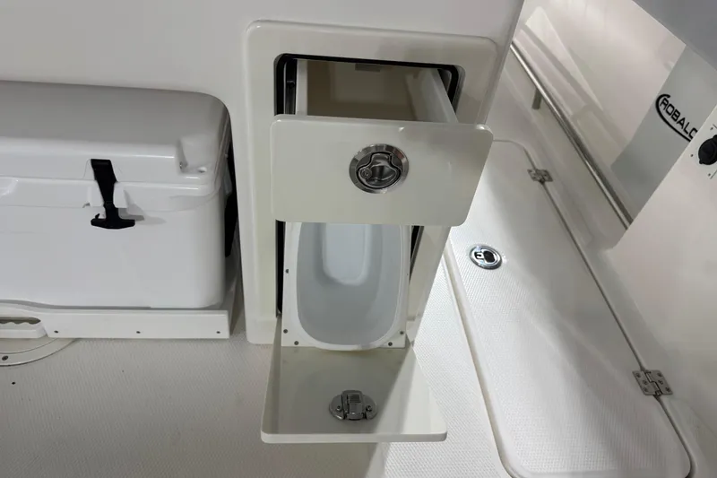 Slide: The Image of 2026 Robalo R300 Center Console boat storage compartment and cooler detail. - 28