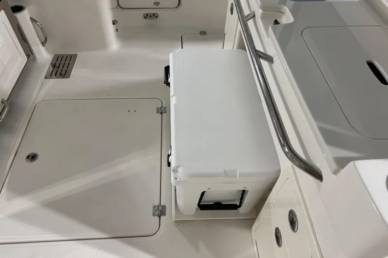 Slide: The Image of Interior of 2026 Robalo R300 Center Console boat with storage and cooler. - 29