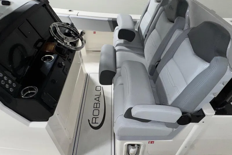 Slide: The Image of 2026 Robalo R300 Center Console interior with sleek helm and comfortable seating. - 4