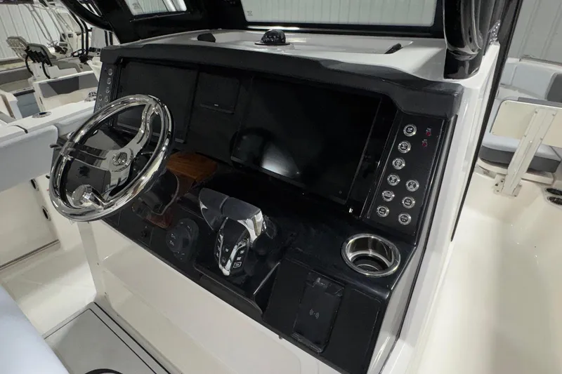 Slide: The Image of 2026 Robalo R300 Center Console dashboard with steering wheel and control panel. - 5