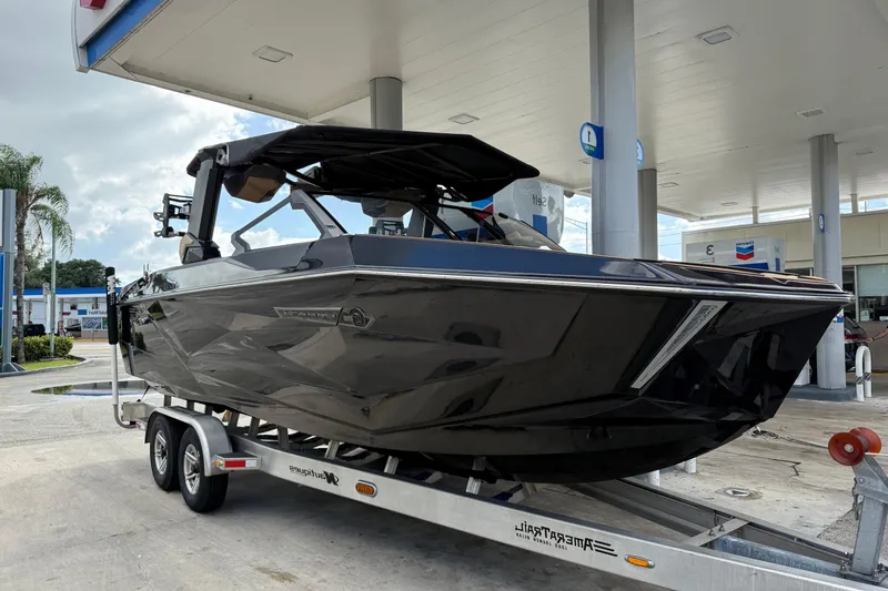 The Image of 2026 Nautique Super Air Nautique G25 Coastal Edition on trailer at gas station. - 0