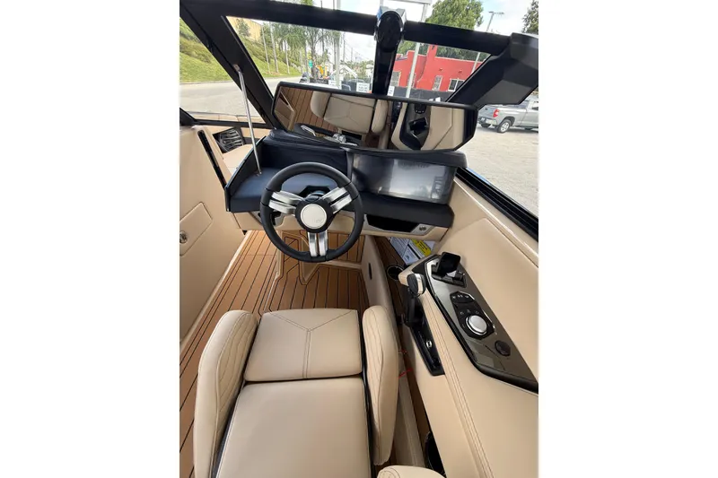 Slide: The Image of 2026 Nautique Super Air Nautique G25 Coastal Edition cockpit with modern steering and controls. - 13