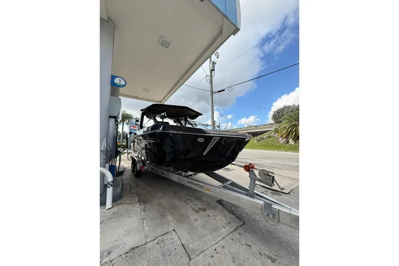 Slide: The Image of 2026 Nautique Super Air Nautique G25 Coastal Edition on trailer at gas station. - 3