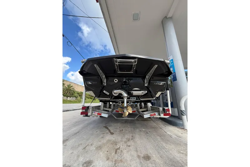 Slide: The Image of 2026 Nautique Super Air Nautique G25 Coastal Edition at a gas station, rear view. - 4