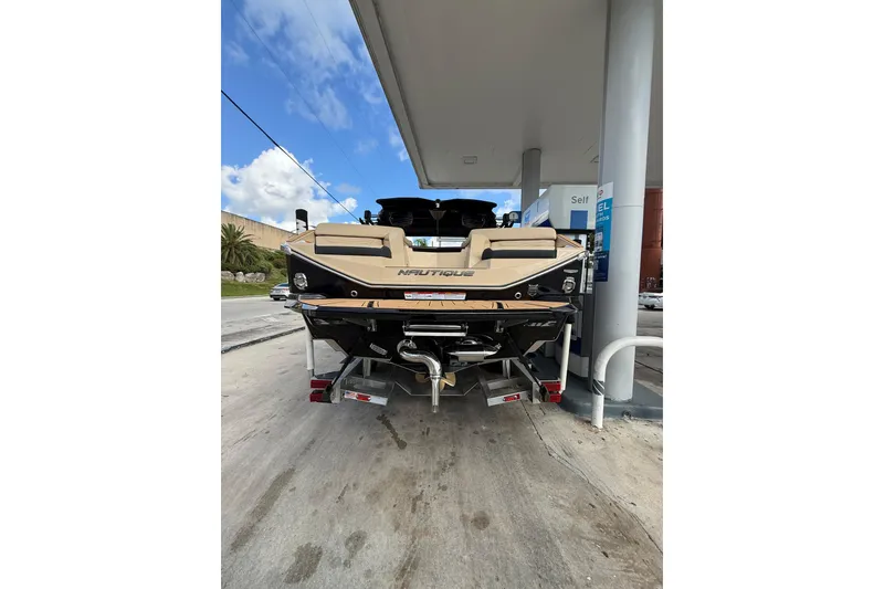 Slide: The Image of 2026 Nautique Super Air Nautique G25 Coastal Edition at a fuel station. - 5