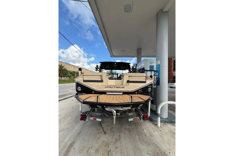 Slide: The Image of 2026 Nautique Super Air Nautique G25 Coastal Edition at a gas station. - 6