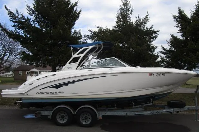 The Image of 2016 Chaparral 264 Sunesta boat on trailer, parked outdoors. - 1