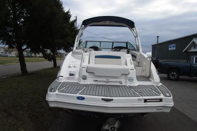 Slide: The Image of 2016 Chaparral 264 Sunesta boat, rear view, parked outdoors on a cloudy day. - 4