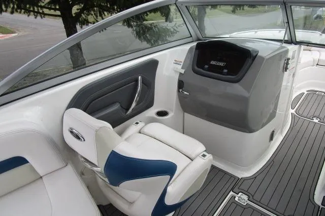 Slide: The Image of 2016 Chaparral 264 Sunesta boat interior with helm and seating area. - 6