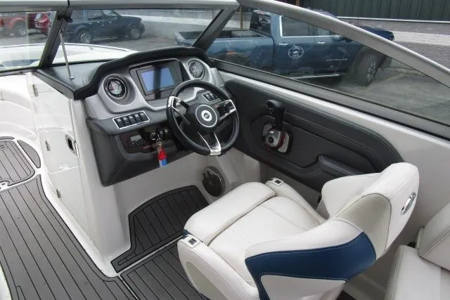 Slide: The Image of Interior of 2016 Chaparral 264 Sunesta boat, featuring modern dashboard and comfortable seating. - 7