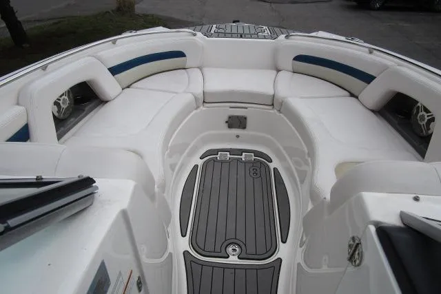 Slide: The Image of 2016 Chaparral 264 Sunesta boat interior with white seating and gray flooring. - 9