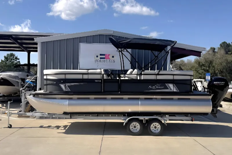 The Image of 2026 SunChaser Vista LR DH pontoon boat on trailer, parked outdoors under clear sky. - 1