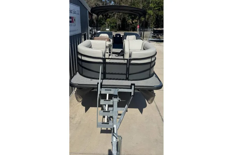 Slide: The Image of 2026 SunChaser Vista LR DH pontoon boat with seating, docked on a sunny day. - 2
