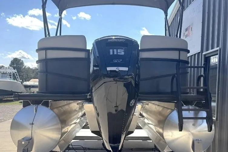 Slide: The Image of 2026 SunChaser Vista LR DH pontoon boat with Mercury 115 engine, docked under a canopy. - 3