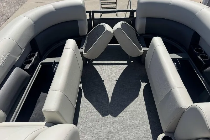 Slide: The Image of 2026 SunChaser Vista LR DH pontoon boat interior with gray seating and cup holders. - 4