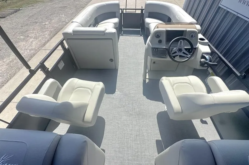 Slide: The Image of Interior view of 2026 SunChaser Vista LR DH pontoon boat with plush seating and steering console. - 8