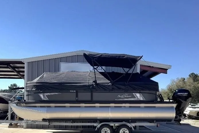 Slide: The Image of 2026 SunChaser Vista LR DH pontoon boat with canopy, parked on a trailer. - 9
