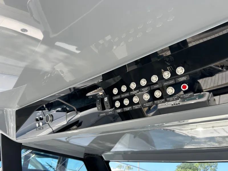 Slide: The Image of The image shows the dashboard of a 2027 Aquila A36MC with various switches. - 18