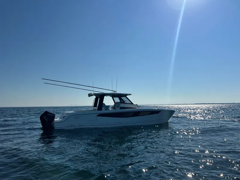 Slide: The Image of Aquila A36MC 2027 on calm water with a clear sky. - 6