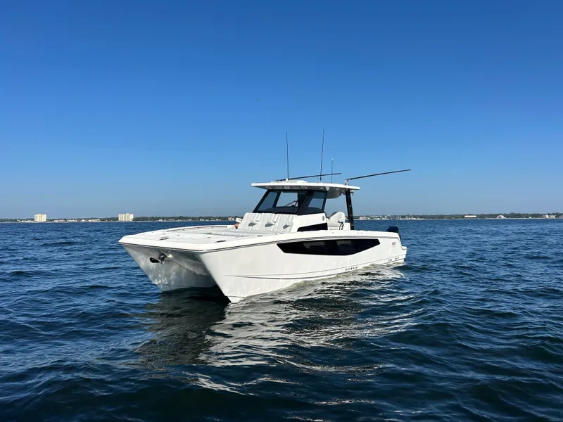 Slide: The Image of A modern Aquila A36MC catamaran on calm waters under a clear sky. - 2