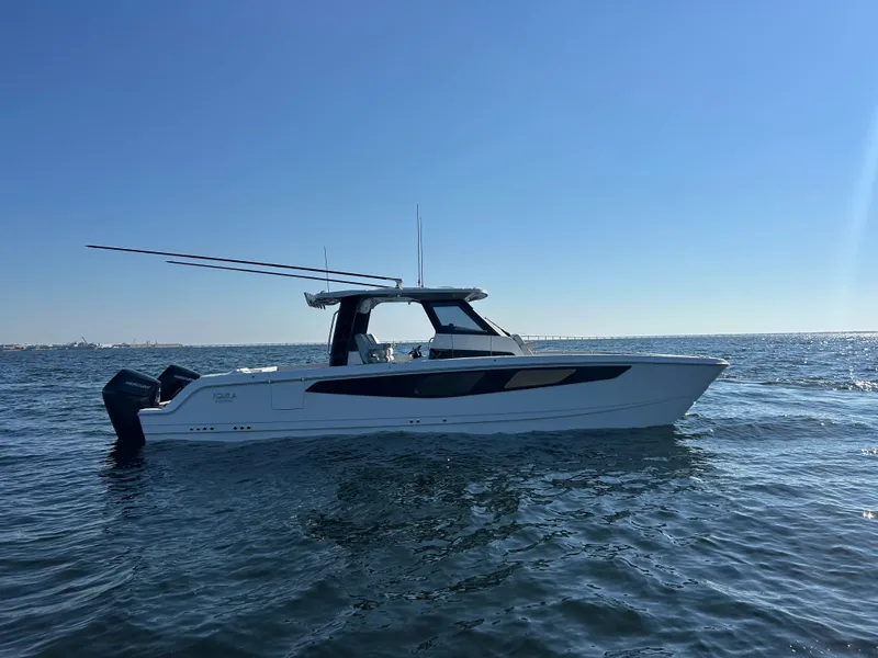 Slide: The Image of The 2027 Aquila A36MC cruises on calm waters under a clear sky. - 5