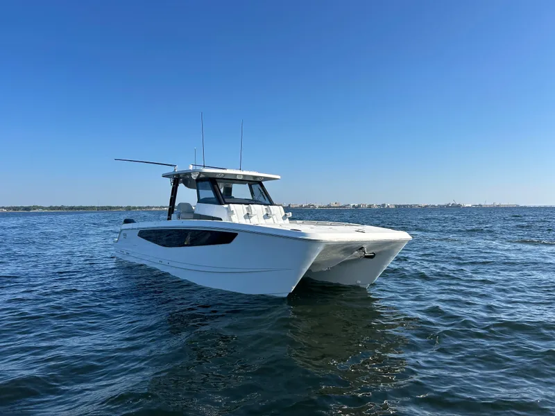 Slide: The Image of A modern Aquila A36MC catamaran on calm waters under a clear sky. - 3