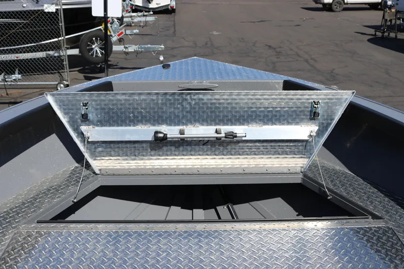 Slide: The Image of Open storage compartment on 2026 Alumaweld Columbia 21 boat, showcasing metal construction. - 12
