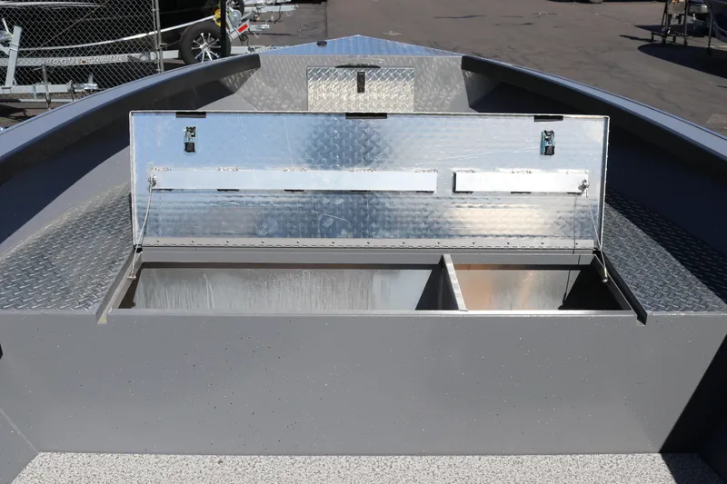 Slide: The Image of Open storage compartment on 2026 Alumaweld Columbia 21 boat, featuring metal construction. - 14