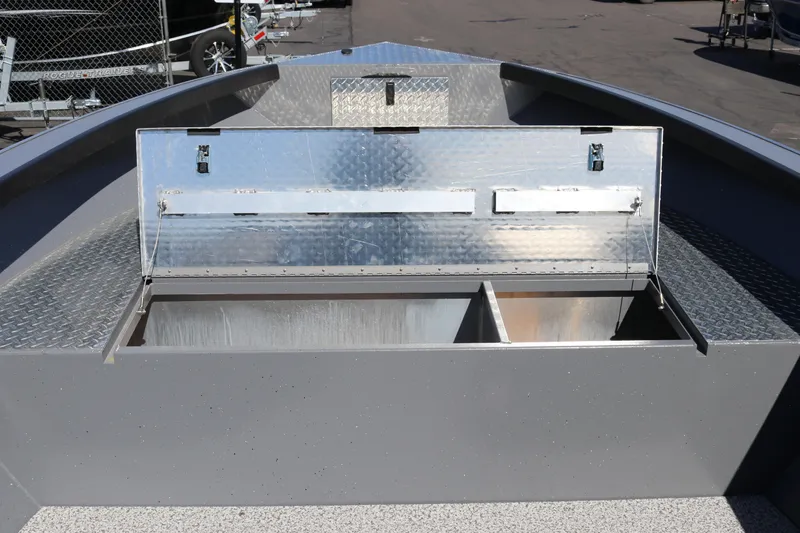 Slide: The Image of Open storage compartment on 2026 Alumaweld Columbia 21 boat, featuring metal interior and diamond plate accents. - 15