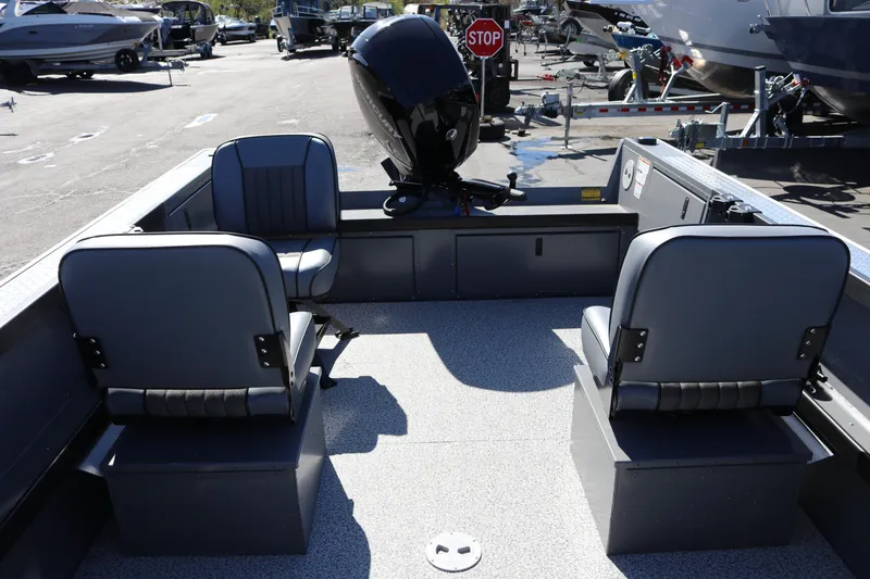 Slide: The Image of 2026 Alumaweld Columbia 21 boat interior with seating and motor, parked in a marina. - 18