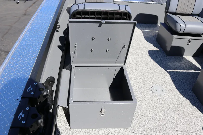 Slide: The Image of Open storage compartment on 2026 Alumaweld Columbia 21 boat deck, showcasing seating and design. - 21