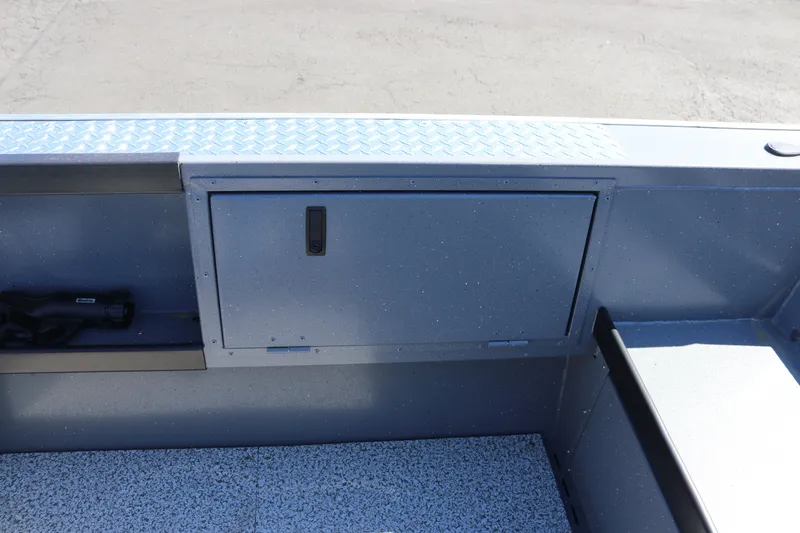 Slide: The Image of 2026 Alumaweld Columbia 21 boat interior with storage compartment and textured flooring. - 22