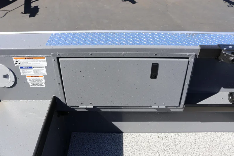 Slide: The Image of 2026 Alumaweld Columbia 21 boat interior with storage compartment and safety labels. - 25