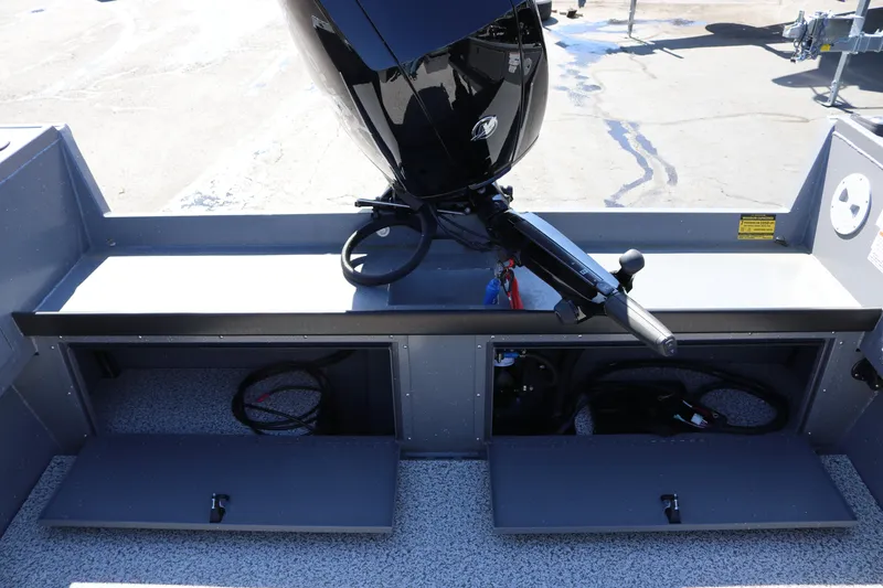 Slide: The Image of 2026 Alumaweld Columbia 21 boat with open storage compartments and motor. - 28