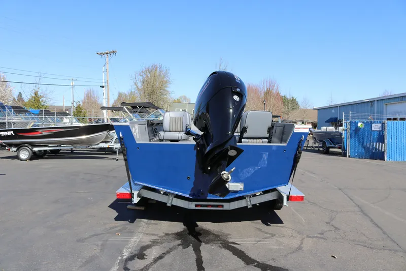 Slide: The Image of 2026 Alumaweld Columbia 21 boat with outboard motor on trailer, parked outdoors. - 3