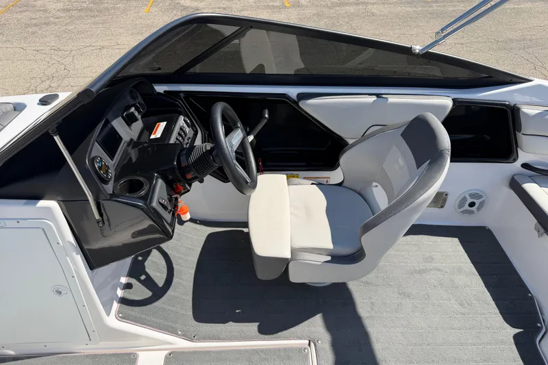 Slide: The Image of 2023 Yamaha Boats SX190 interior with steering wheel and seating. - 12