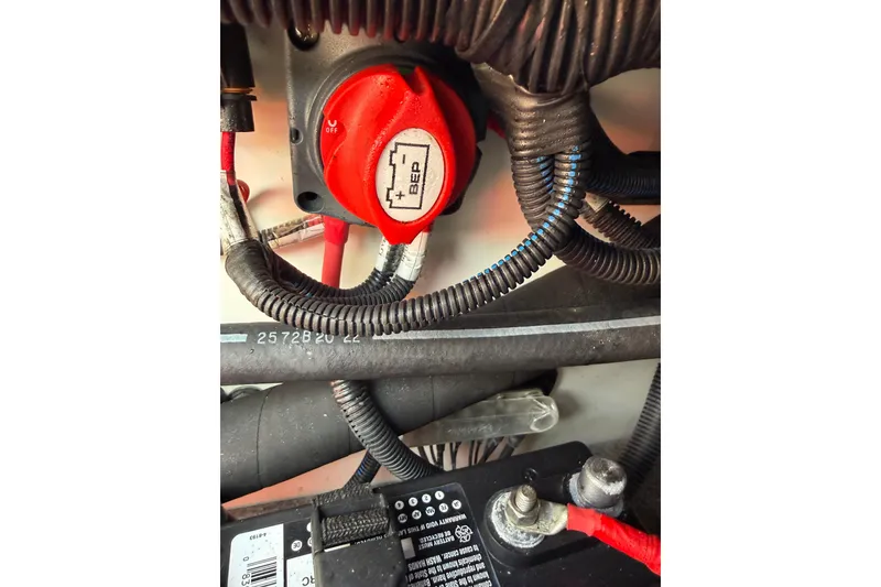 Slide: The Image of 2023 Yamaha Boats SX190 battery compartment with wiring and switch details. - 5