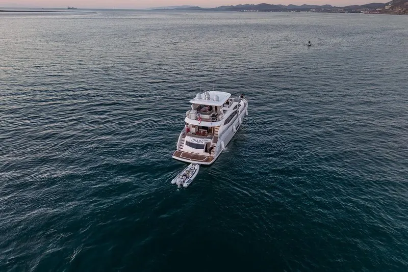 Slide: The Image of Luxurious 2012 Sunseeker Manhattan 73 yacht on calm ocean waters at sunset. - 12