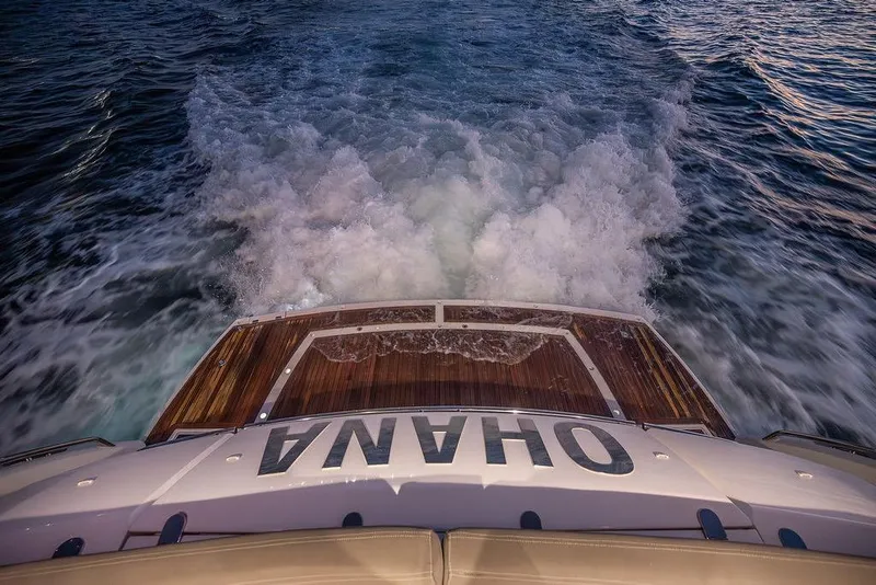 Slide: The Image of Sunseeker Manhattan 73 yacht cruising, rear view, 2012 model, ocean waves behind. - 20