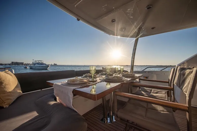Slide: The Image of Luxurious dining setup on 2012 Sunseeker Manhattan 73 yacht at sunset. - 24