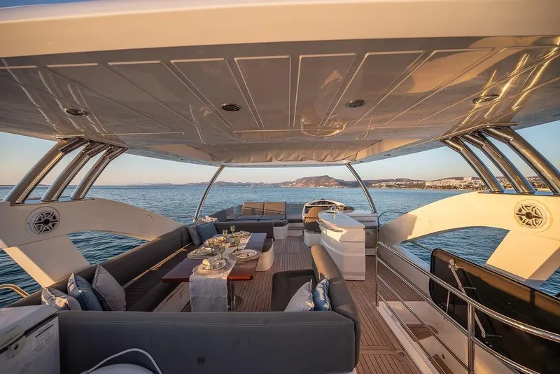 Slide: The Image of Luxurious 2012 Sunseeker Manhattan 73 yacht interior with elegant dining setup and ocean view. - 25