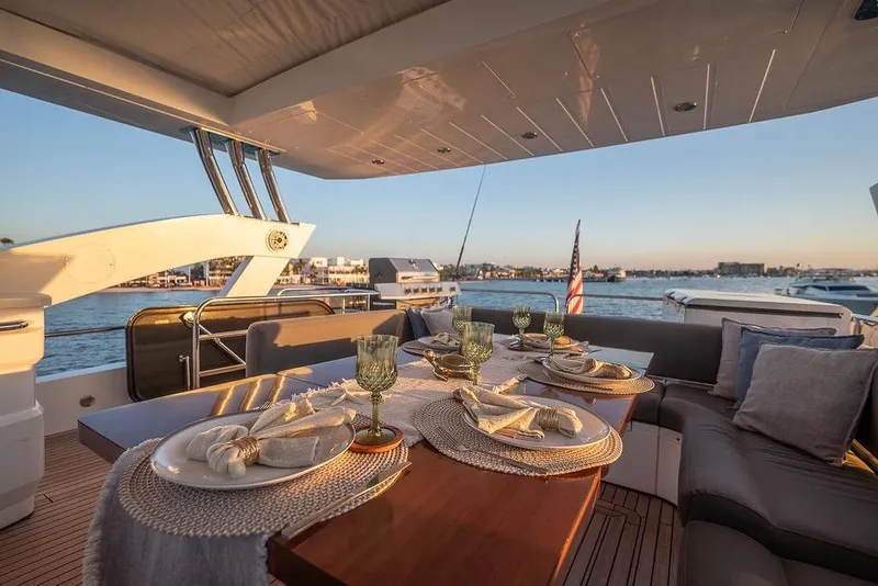 Slide: The Image of Luxurious dining setup on 2012 Sunseeker Manhattan 73 yacht, overlooking serene waterfront. - 28