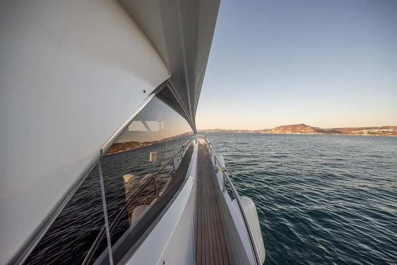 Slide: The Image of Side view of 2012 Sunseeker Manhattan 73 yacht cruising on calm waters at sunset. - 32