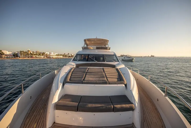 Slide: The Image of Luxurious 2012 Sunseeker Manhattan 73 yacht cruising on serene waters at sunset. - 34